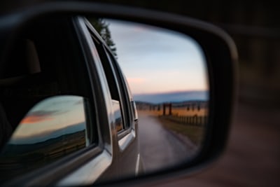 A landscape view through a driver's side view mirror.