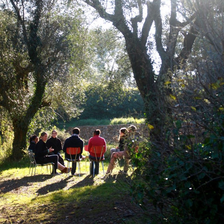 A group of people sitting in nature.