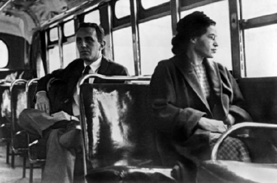 This iconic photo captures Rosa Parks seated on a Montgomery, Alabama, bus in 1956, after the Supreme Court declared bus segregation unconstitutional. The image symbolizes the success of the Montgomery bus boycott. 