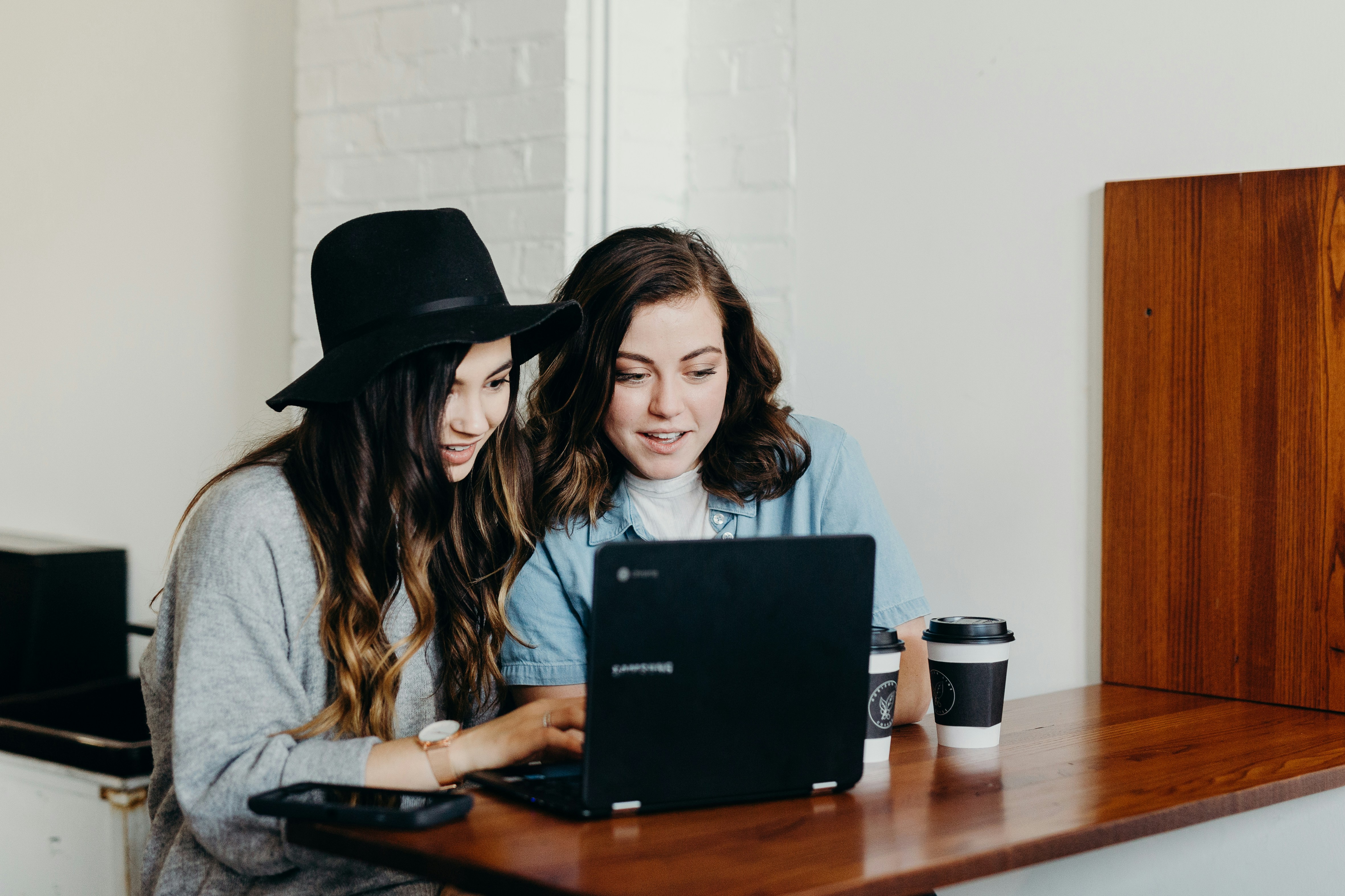 two girls sitting at a computer