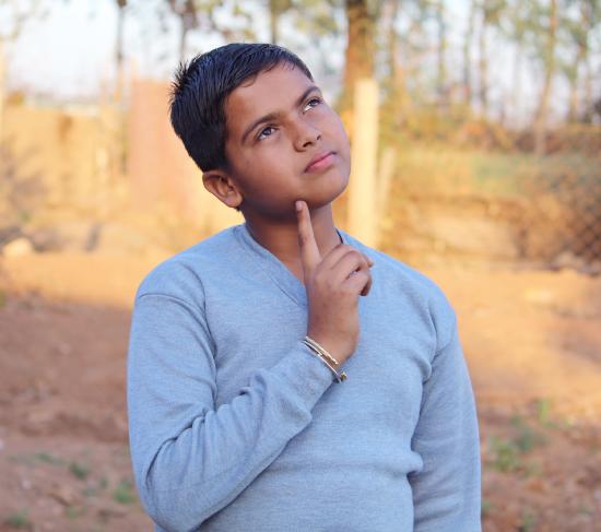 A boy shown deep in thought