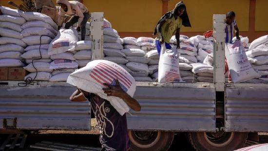 Volunteers at the Zanzalima Camp for Internally Displaced People unload an aid delivery from USAID in 2021 in Bahir Dar, Ethiopia. 