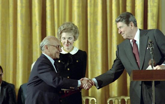 President Ronald Reagan awards economist Milton Friedman the Presidential Medal of Freedom in 1988.