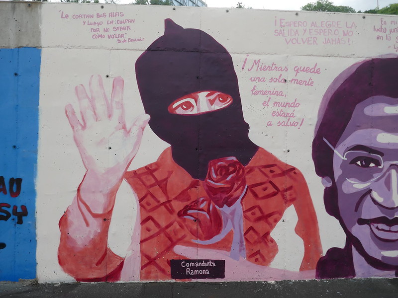 Mural of Comandanta Ramona wearing traditional clothing and a face covering showing only her eyes