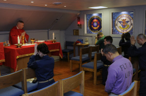 Flickr_-_Official_U.S._Navy_Imagery_-_A_chaplain_leads_Roman_Catholic_Mass_in_the_ship’s_chapel.-300x199.jpg