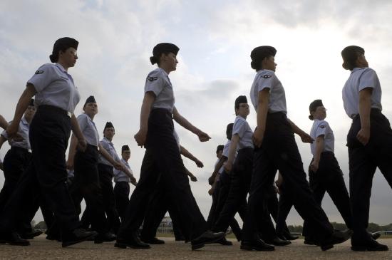 About a dozen female members of the U.S. Air Force are shown marching in formation.