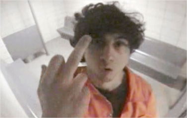 The "Boston bomber", Dzhokhar Tsarnaev makes an insult gesture from his jail cell.