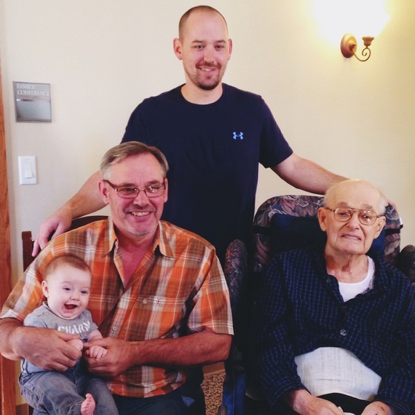 A family photo of four generations of men from great grandfather to great grandson.
