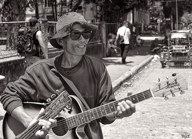 A street Musician holding his guitar