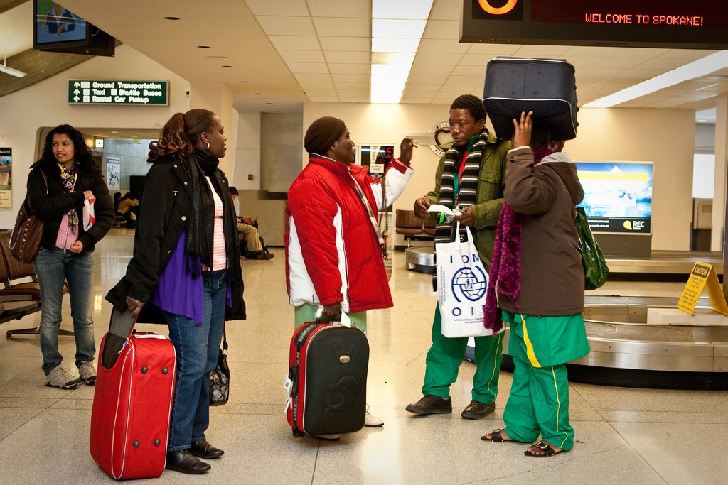 A Congolese family being met at the airport by their case worker