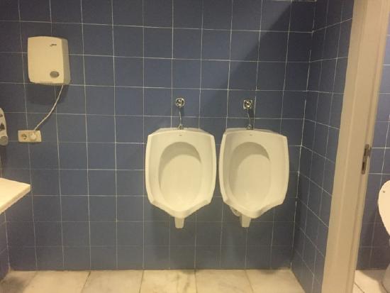 image of two urinals very close together in a men's bathroom in Spain