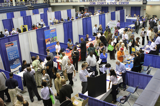 Photo looking down on a crowded convention hall during a job fair