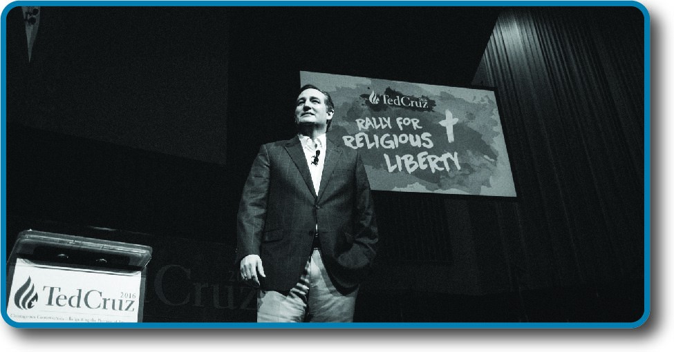 An image of Ted Cruz standing in front of a sign that reads