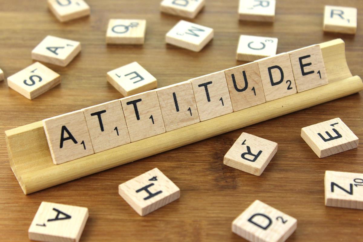 Scrabble pieces arranged to spell out "attitude."