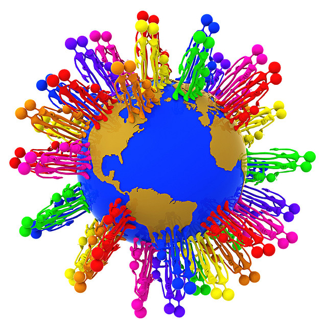 Computer generated image of the earth with groups of people standing around. Each group is a different color of the rainbow.