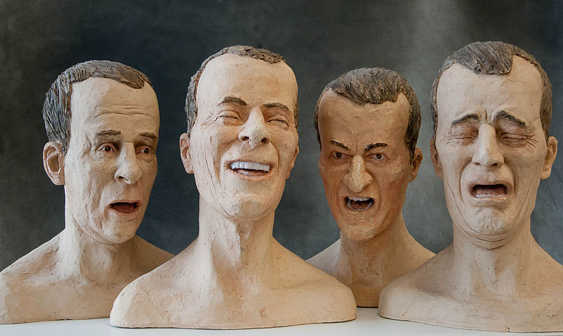 Four sculptures of a man showing four different expressions: fear, anger, contempt, and disgust.