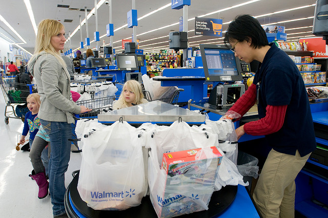 Woman checking out groceries at Walmart.