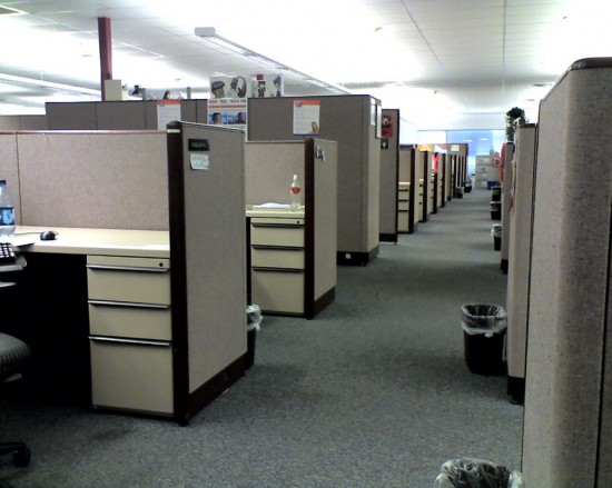 An office with a long row of cubicles is shown