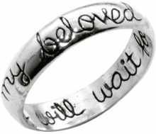 A silver ring with the words "My beloved will wait" inscribed.