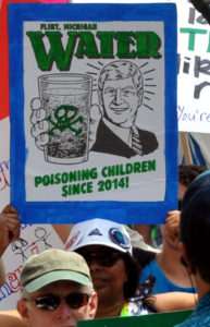 Poster that says "Flint, Michigan: Water. Poisoning children since 2014."
