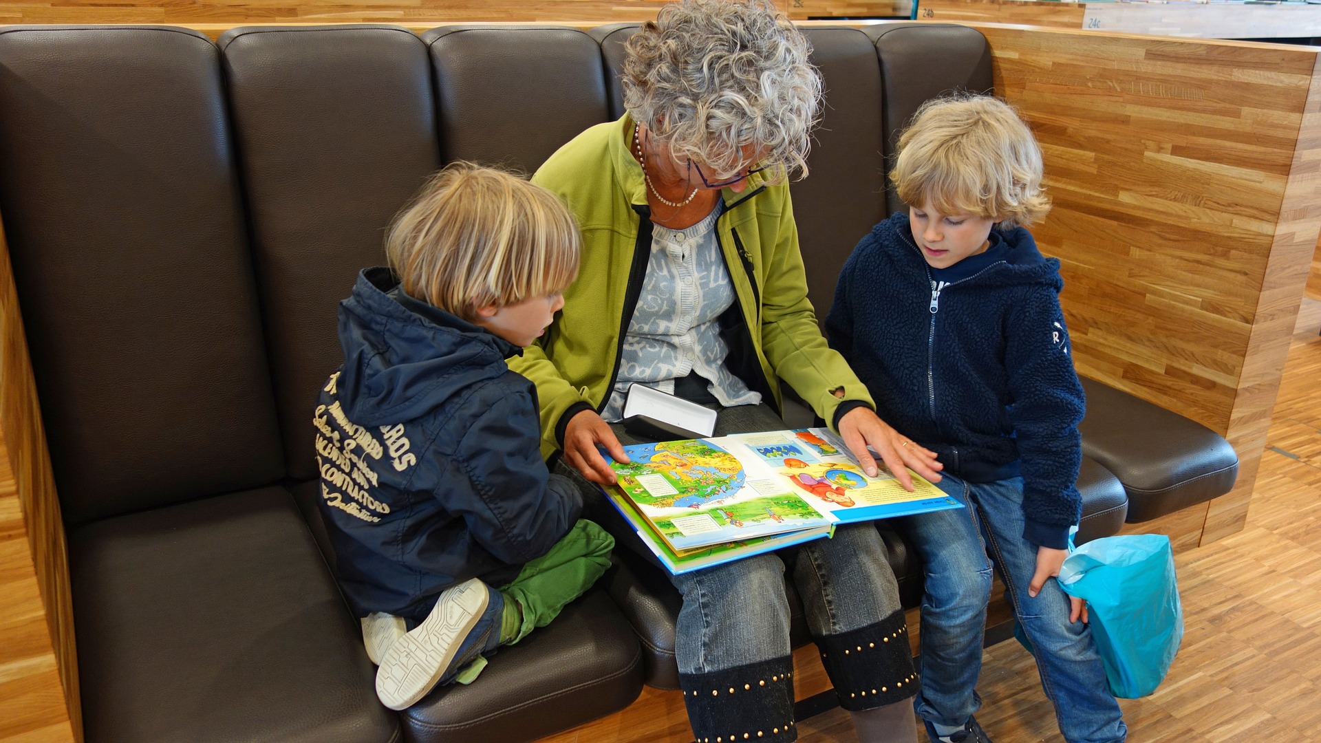Woman reading to two young children