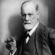 Freud. He has a stern look on his face, a short, white beard, and a cigar in his hand.
