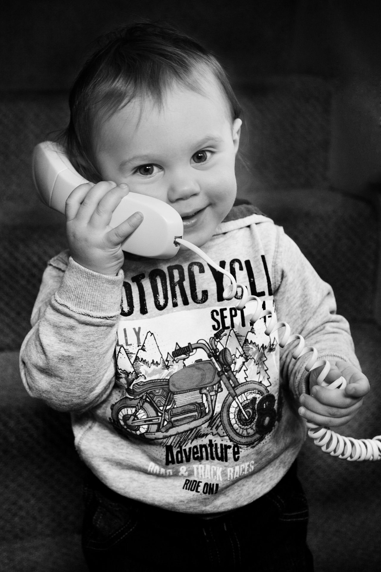 Baby boy talking on phone.