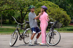 African-American couple preparing for a bike ride.