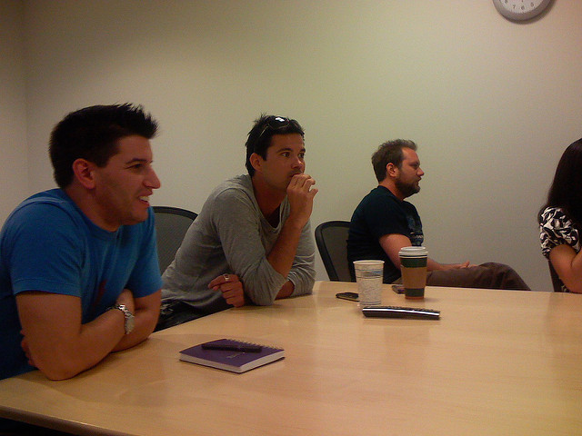 A group of men listening during a meeting