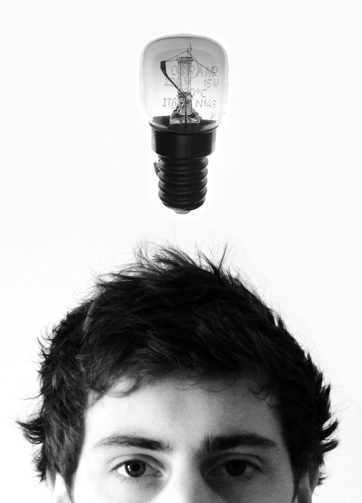 A man with a lightbulb above his head