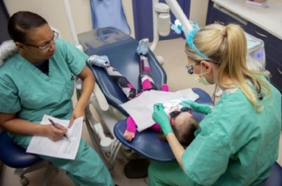 A child receives dental treatment during the â��Give Kids a Smileâ�� day event March 9, 2019, held by the 375th Dental Squadron clinic on Scott Air Force Base, Illinois.  Children registered for the event were given the chance to receive cleanings, fillings, and more to at no cost to their parents.  (U.S. Air Force photo by Airman 1st Class Isaiah Gonzalez)