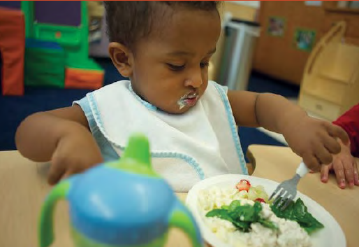 toddler self-feeding with a child-sized fork
