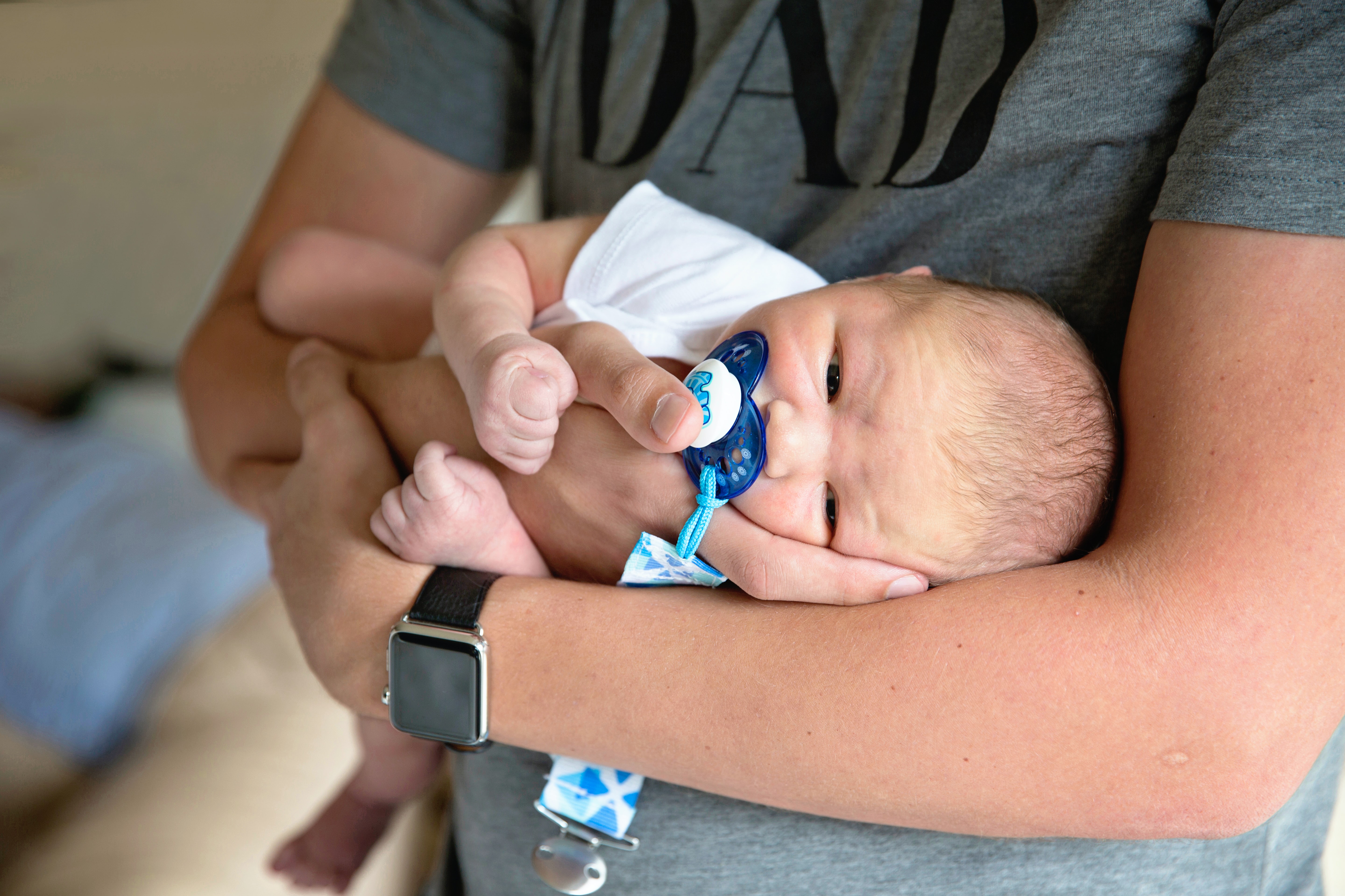 A man holds a small baby.