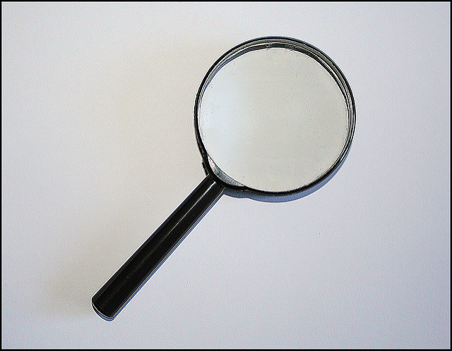 Magnifying glass laying on a white background.