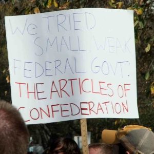 Protest sign saying that we already tried small, weak government under the Articles of Confederation.