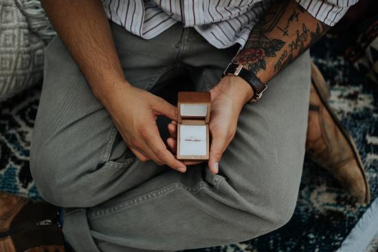 A man holding a boxed wedding ring