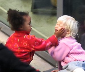 photo of child with her hand on another childs face