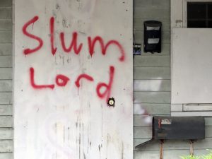 graffiti that says slum lord