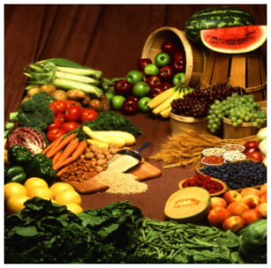 Photograph of table full of vegetables and fruits.