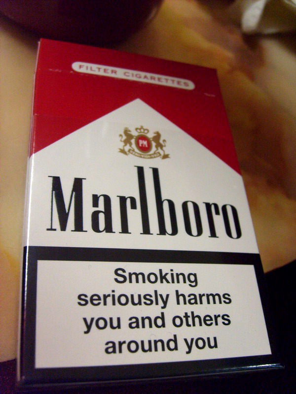 a pack of Marlboro cigarettes that reads, "Smoking seriously harms you and others around you".