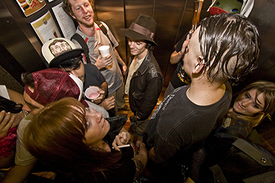 Overhead shot of a group of young adults talking in an elevator