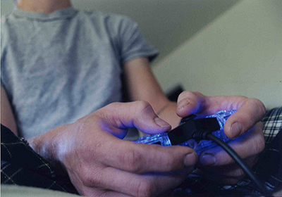 Hands of a man with a game controller, playing