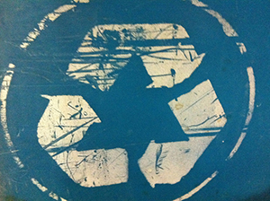 Faded and worn recycling sign.