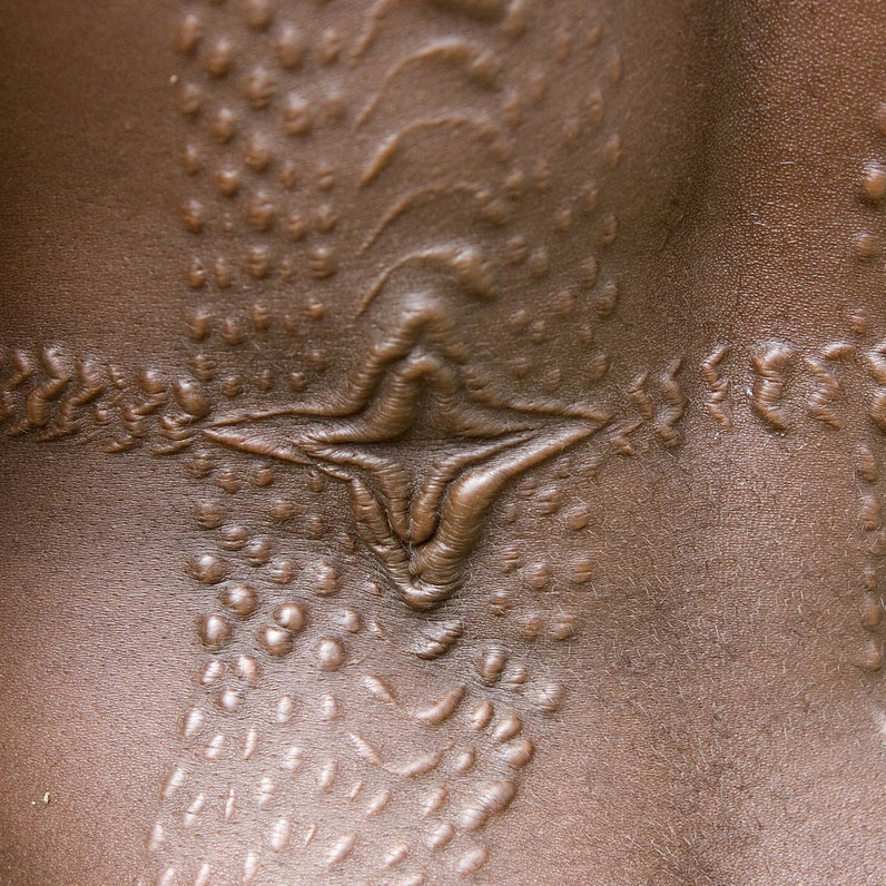 The scars designed to look like crocodile skin on a tribesman's back