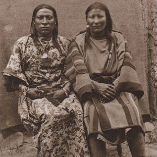 Two Native Americans sitting side by side in a black and white photo.