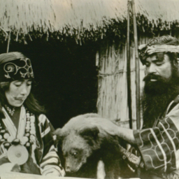 Ainu man and woman with a bear skin.