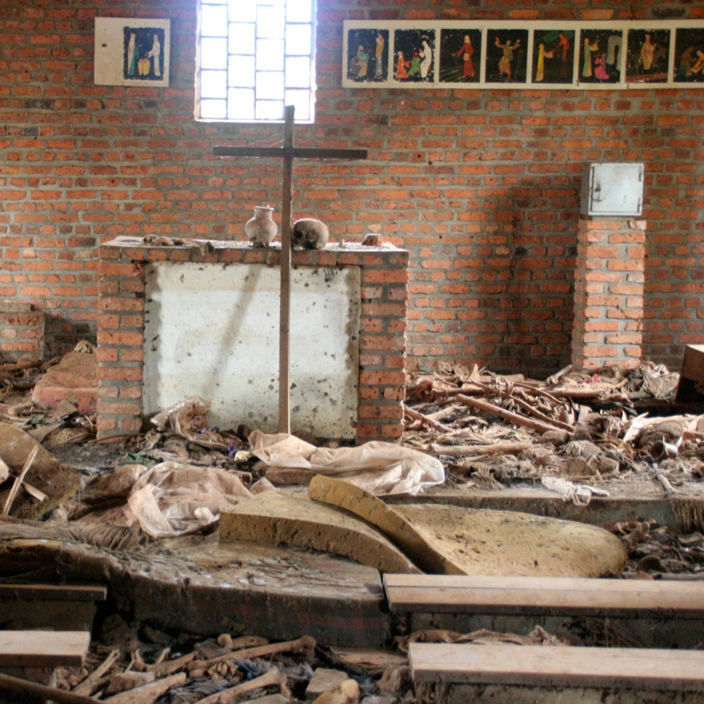 a church altar in rubble of broken pews, and human bones and clothing