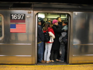 How would a visitor from the suburban United States act and feel on this crowded New York train?