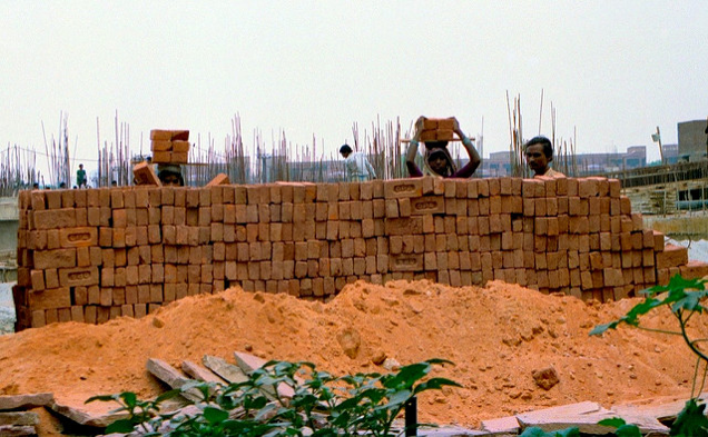 India used to have a rigid caste system. The people in the lowest caste suffered from extreme poverty and were shunned by society. Some aspects of India’s defunct caste system remain socially relevant. In this photo, Indian women of a specific Hindu caste works in construction, and demolishes and builds houses.