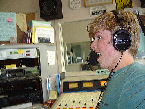 Radio presenter with earphones